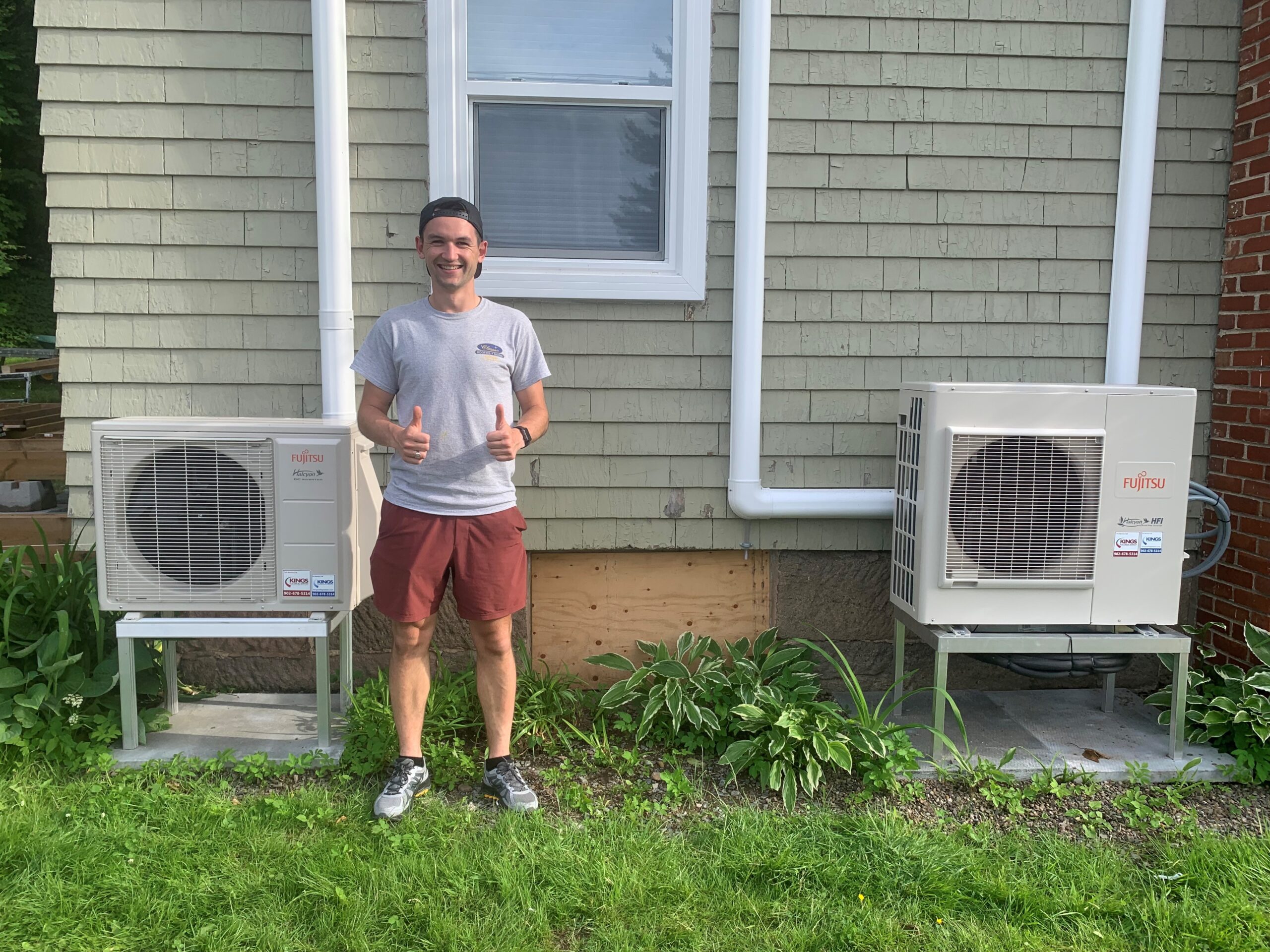 Corey Cadeau double thumbs up with double heat pumps outdoors scaled